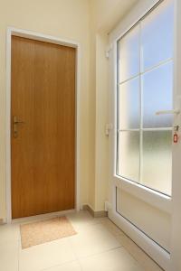 a wooden door in a room with a window at Apartments with a parking space Lumbarda, Korcula - 9474 in Lumbarda