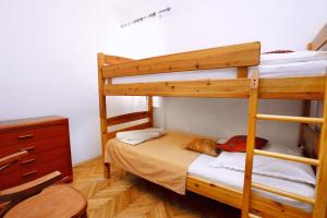 a bedroom with two bunk beds and a dresser at Apartment Duce 10303a in Duće