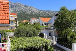 a city with houses and a mountain in the background at Apartments with a parking space Orebic, Peljesac - 10102 in Orebić