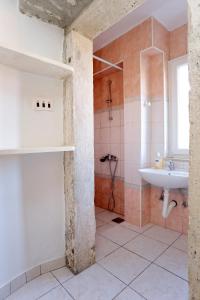 a bathroom with a sink and a shower at Apartments by the sea Korcula - 10043 in Korčula