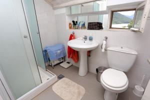 a bathroom with a toilet and a sink and a shower at Secluded fisherman's cottage Ston - Supavao, Peljesac - 9485 in Ston