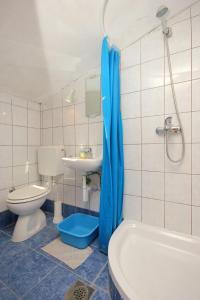 a bathroom with a toilet and a sink and a tub at Apartments by the sea Orebic, Peljesac - 10094 in Orebić