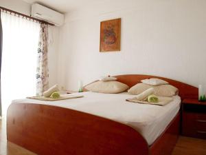 a bedroom with a bed with two towels on it at Apartments with parking space Orebic, Peljesac - 10088 in Orebić
