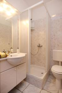 a bathroom with a shower and a sink and a toilet at Apartments with parking space Orebic, Peljesac - 10088 in Orebić +29 photos