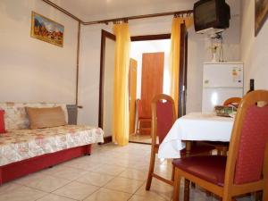 a living room with a table and a couch and a kitchen at Apartments with parking space Orebic, Peljesac - 10088 in Orebić