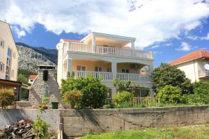 a large house with a balcony on top of it at Apartments with a parking space Orebic, Peljesac - 10092 in Orebić