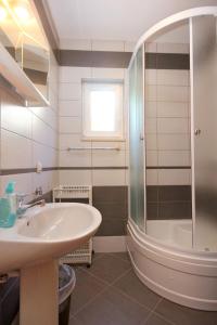 a bathroom with a sink and a shower at Apartments with a parking space Orebic, Peljesac - 10092 in Orebić