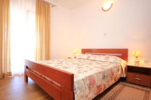 a bedroom with a bed and a large window at Apartments with a parking space Orebic, Peljesac - 10092 in Orebić