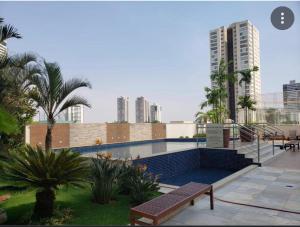 a swimming pool in a city with tall buildings at Lindo flat Easy Life in Goiânia
