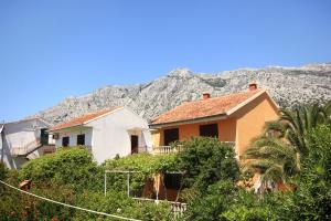 a house with a mountain in the background at Apartments with parking space Orebic, Peljesac - 10159 in Orebić