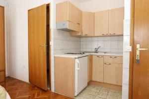 a small kitchen with a sink and a stove at Apartments with a parking space Trpanj, Peljesac - 10111 in Trpanj