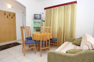 a living room with a table and chairs and a couch at Apartments by the sea Viganj, Peljesac - 10116 in Viganj
