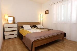 - une chambre avec un lit, une commode et une fenêtre dans l'établissement Apartments with a parking space Orebic, Peljesac - 10149, à Orebić