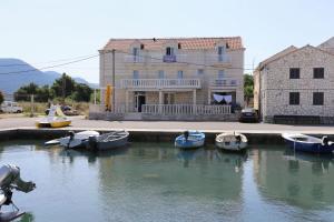 a group of boats docked in a body of water at Apartments and rooms by the sea Hodilje, Peljesac - 10234 in Ston