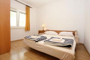 a bedroom with a bed with towels on it at Apartments by the sea Zuljana, Peljesac - 10207 in Žuljana