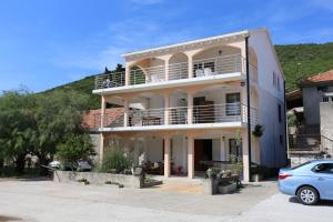 a large house with a car parked in front of it at Apartments by the sea Brijesta, Peljesac - 10223 in Brijesta