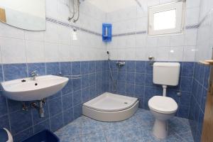 a bathroom with a toilet and a sink at Apartments by the sea Brijesta, Peljesac - 10223 in Brijesta