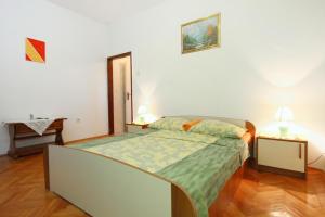 a bedroom with a bed and two night stands at Apartments with a parking space Orebic, Peljesac - 10177 in Orebić