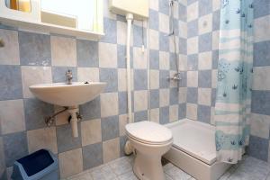 a bathroom with a sink and a toilet and a sink at Apartments by the sea Zuljana, Peljesac - 10228 in Žuljana
