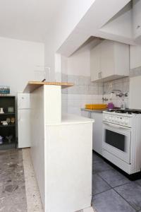 a kitchen with white cabinets and a stove at Holiday apartments Duba Peljeska, Peljesac - 10230 in Orebić