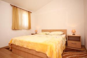 ein Schlafzimmer mit einem Bett mit einer gelben Decke in der Unterkunft Holiday house with a parking space Orebic, Peljesac - 10165 in Orebić