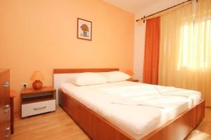 a bedroom with a large bed with white sheets at Apartments with a parking space Orebic, Peljesac - 10171 in Orebić