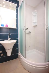 a bathroom with a sink and a shower at Apartments with parking space Orebic, Peljesac - 10173 in Orebić