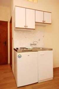 a kitchen with a sink and a white refrigerator at Studio Orebic 10256b in Orebić