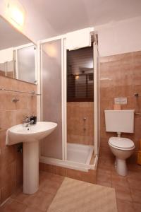 a bathroom with a shower and a sink and a toilet at Apartment Orebic 10153f in Orebić