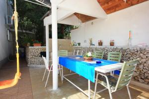 a blue table and chairs on a patio at Apartment Mastrinka 10261b in Trogir