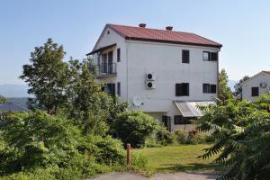 a large white building with a red roof at Apartments with a parking space Njivice, Krk - 9668 in Njivice
