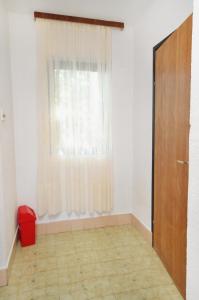 an empty room with a window and a door at Apartments with a parking space Njivice, Krk - 9668 in Njivice