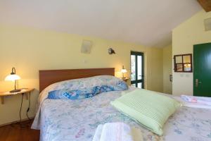a bedroom with a large bed with a bedspread at Apartments for families with children Sveta Jelena, Opatija - 9676 in Martina