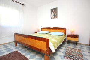 a bedroom with a large bed and a window at Apartments by the sea Marina, Trogir - 9677 in Marina
