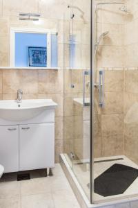 ein Bad mit einer Glasdusche und einem Waschbecken in der Unterkunft Apartments by the sea Rogac, Solta - 11655 in Grohote
