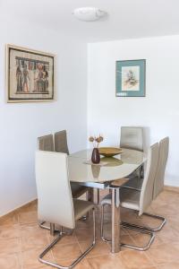 a dining room with a table and chairs at Apartments by the sea Rogac, Solta - 11655 in Grohote