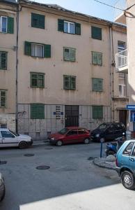 a parking lot with cars parked in front of a building at Apartments with WiFi Split - 11660 in Split