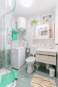 a bathroom with a toilet and a sink and a shower at Apartments with WiFi Split - 11660 in Split