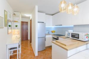 a kitchen with a white refrigerator and a counter at Apartments with WiFi Split - 11660 in Split
