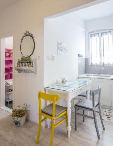 a kitchen with a white table and two chairs at Apartments by the sea Komiza, Vis - 11671 in Komiža
