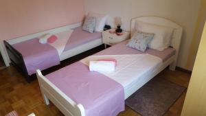 2 camas en una habitación con sábanas rosas y blancas en Apartments with WiFi Split - 11680 en Split