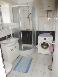 a bathroom with a shower and a washing machine at Apartments with WiFi Split - 11692 in Split