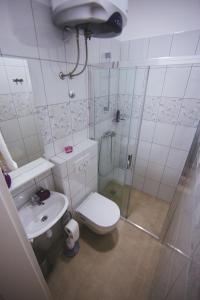 a bathroom with a shower and a toilet and a sink at Apartments with a parking space Split - 11690 in Split