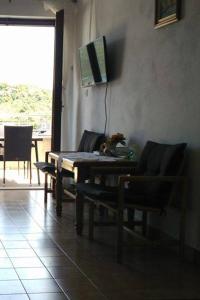 a living room with two chairs and a table and a television at Apartments by the sea Kabli, Peljesac - 11695 in Brijesta