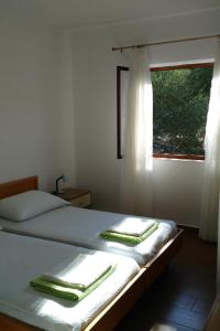 a bedroom with a bed with two towels on it at Apartments by the sea Kabli, Peljesac - 11695 in Brijesta