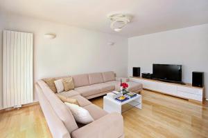a living room with a couch and a tv at Holiday house with a swimming pool Lozovac, Krka - 11715 in Lozovac