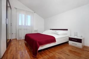 a white bedroom with a bed with a red blanket at Holiday house with a swimming pool Lozovac, Krka - 11715 in Lozovac +14 photos
