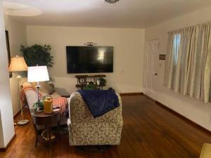 a living room with a couch and a tv at Lake Murray House in La Mesa