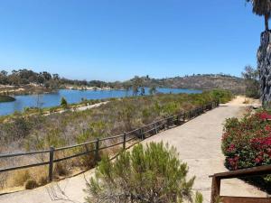 a path next to a river with a fence at Lake Murray House in La Mesa