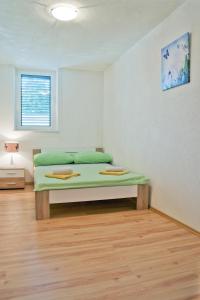 a bedroom with a green bed in a room at Apartments with a parking space Split - 11726 in Split